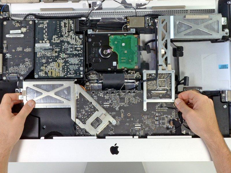 Step 25 Simultaneously, lift and rotate the logic board out of the imac.