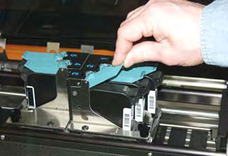 The cartridges are held in place by a latch lever mounted on the inkjet cartridge holder (pen stall). Release the lever by raising it vertical. 3.