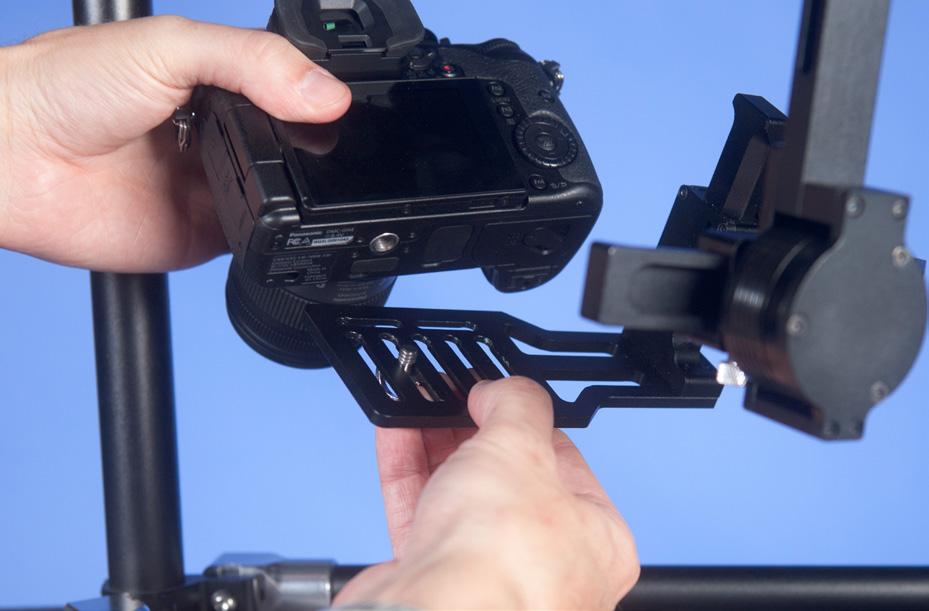 Place the camera on camera tray and attach with ¼ screw. Pick appropriate slot that will accept your cameras size and weight.