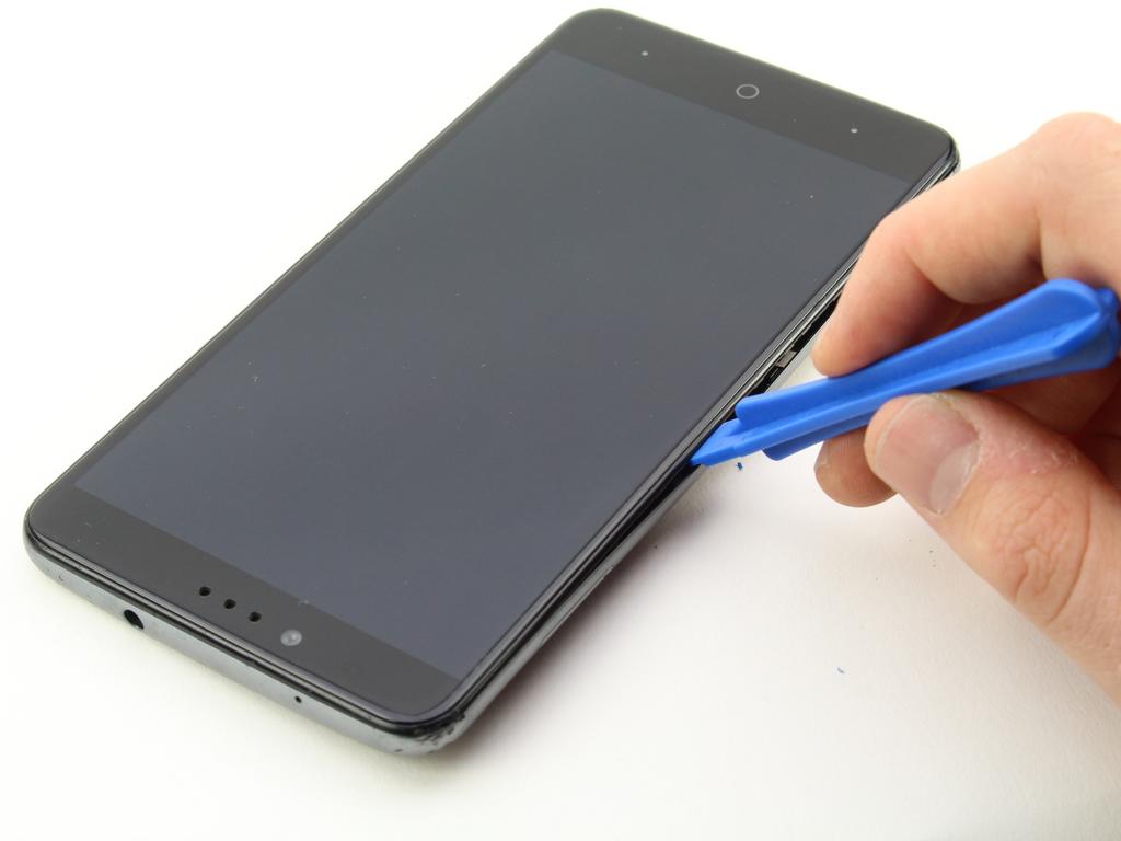 Push up on the opening tool to separate the panel from the phone.