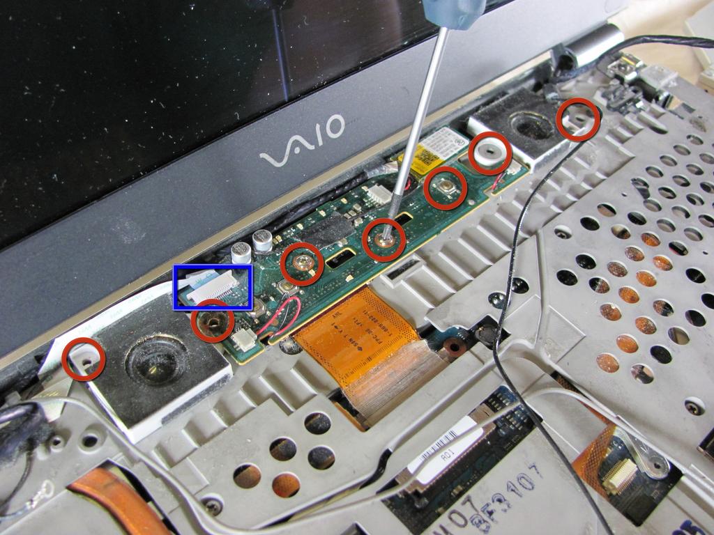 Before removing the assembly, disconnect the ribbon cable located at the top left