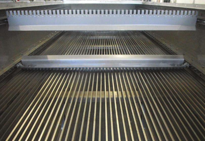 Solids accumulate as wastewater travels through the screening section and are continuously removed via multiple rakes.