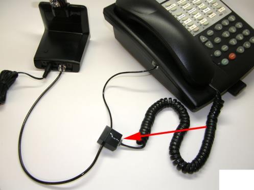 Set up with A Handset Lifter: Locate the Telephone Interface Cable. It will have plastic modular plugs on each end and a black connector in the middle of the cable.