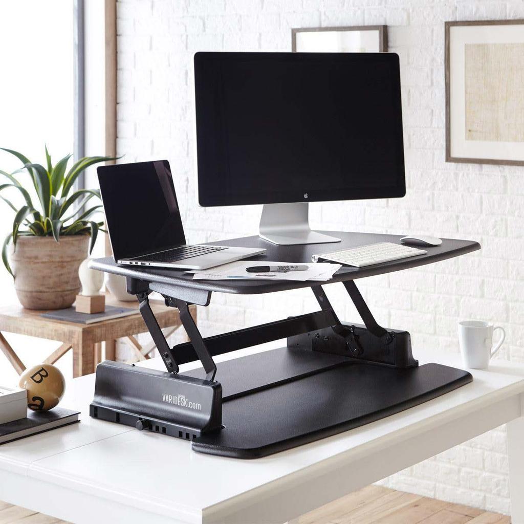 It features a 76cm wide, single level platform that the monitor and keyboard rest on when you are standing. The keyboard tray slides in and out at desk level.