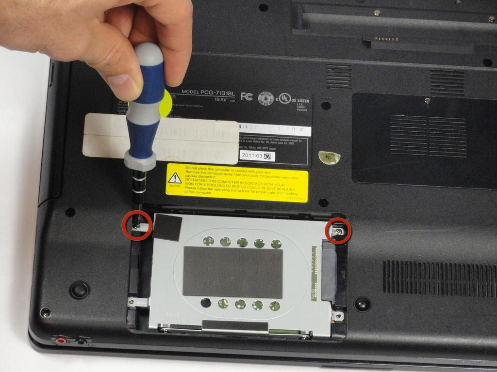 Step 9 The hard drive should now be exposed. Remove the two remaining 7.75-mm screws using the Phillips #00 screwdriver.