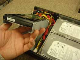 Gently lift the hard drive out of the bay, and disconnect the SATA power and SATA data cable from the hard