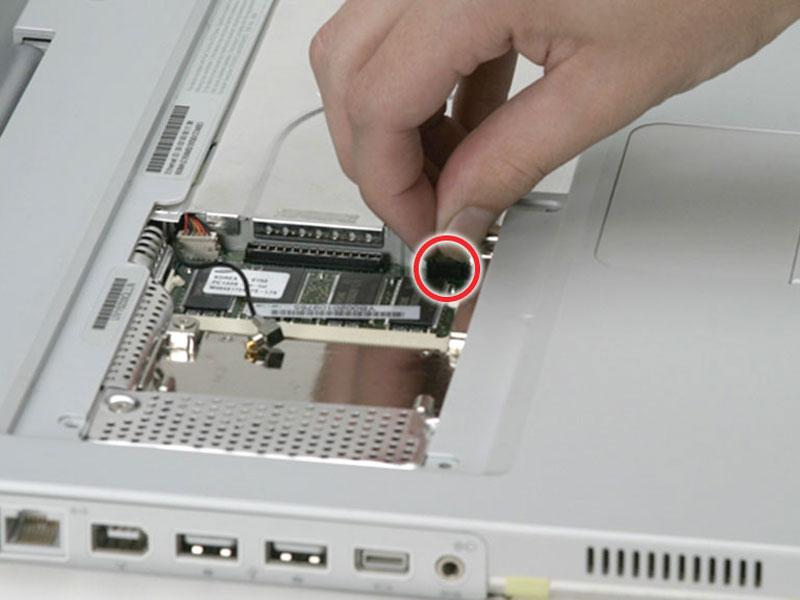 After disengaging the locking bar, slide the cable out of the connector.