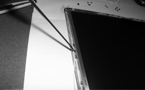 5. Press the hook on the both side of LCD with a (-)