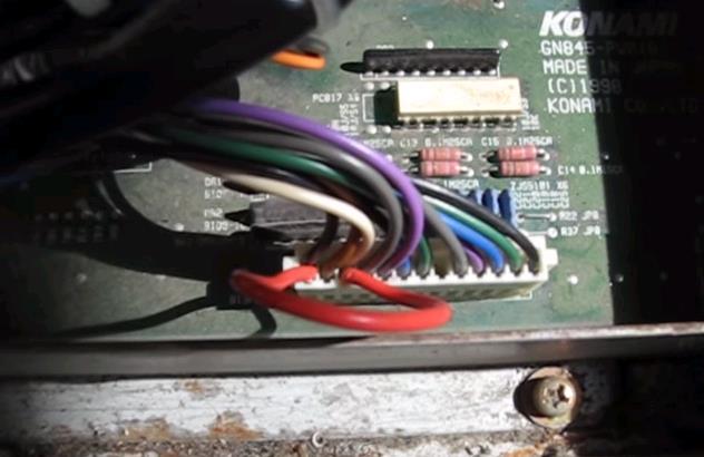 Here is one of the two dance stage boards where they have added the red jumper wire between the black and white wires by jamming the end of the wire down into the connector so it touches the metal