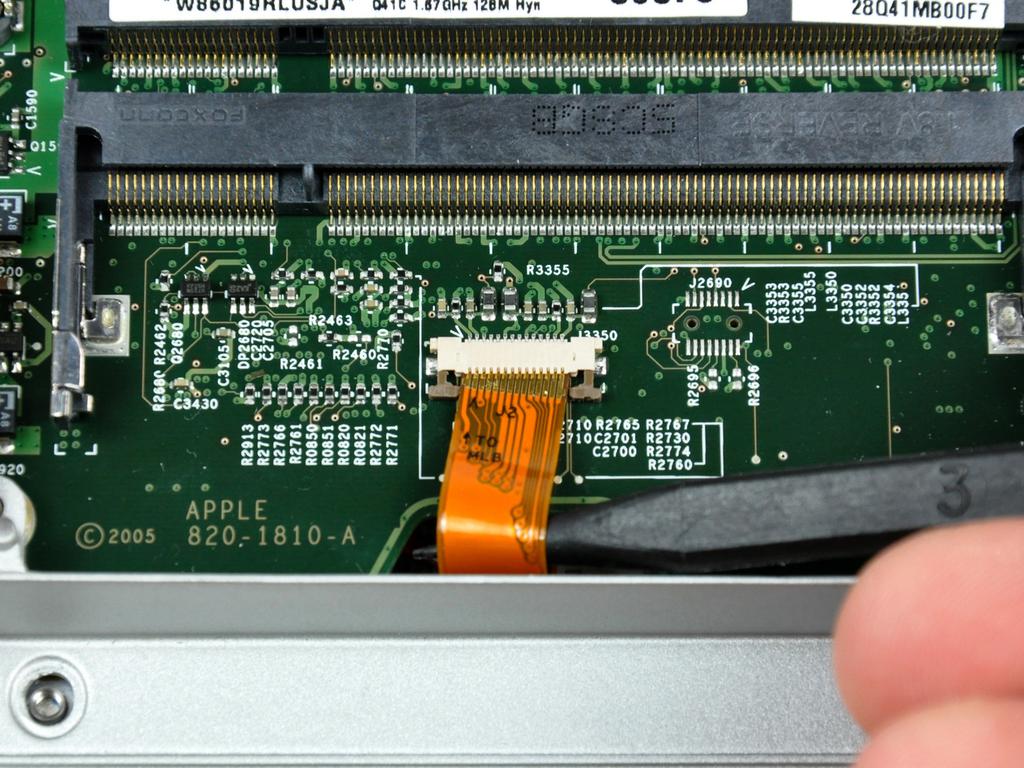 Step 6 Use the tip of a spudger to slide the trackpad ribbon cable out of its socket.
