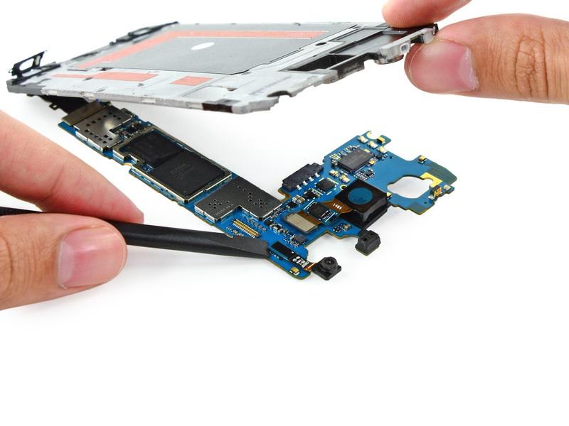 Lay the motherboard on a clean flat surface and support the interior midframe with one hand,