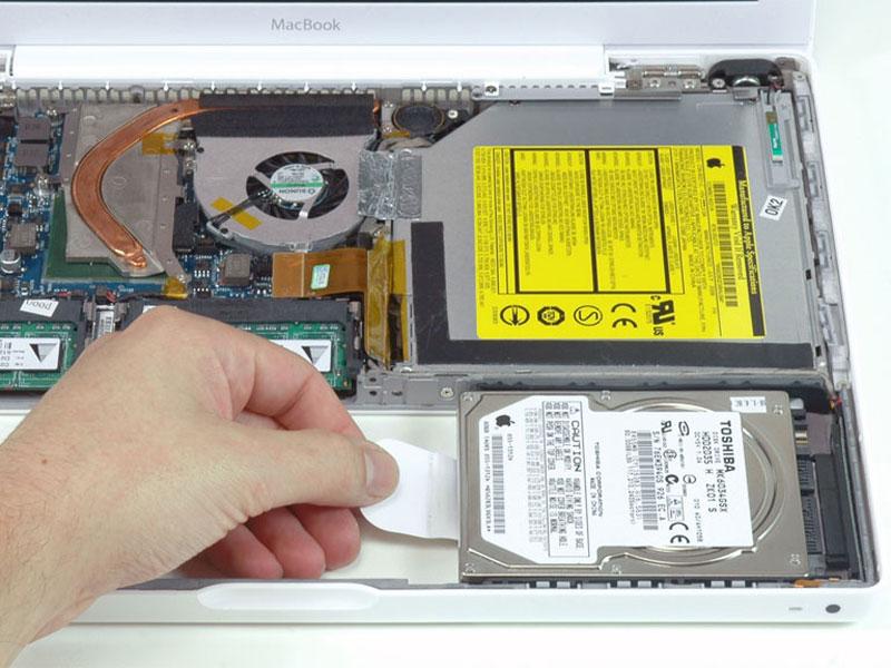 Step 13 Optical Drive Grasp the white plastic tab attached to the hard drive and pull it