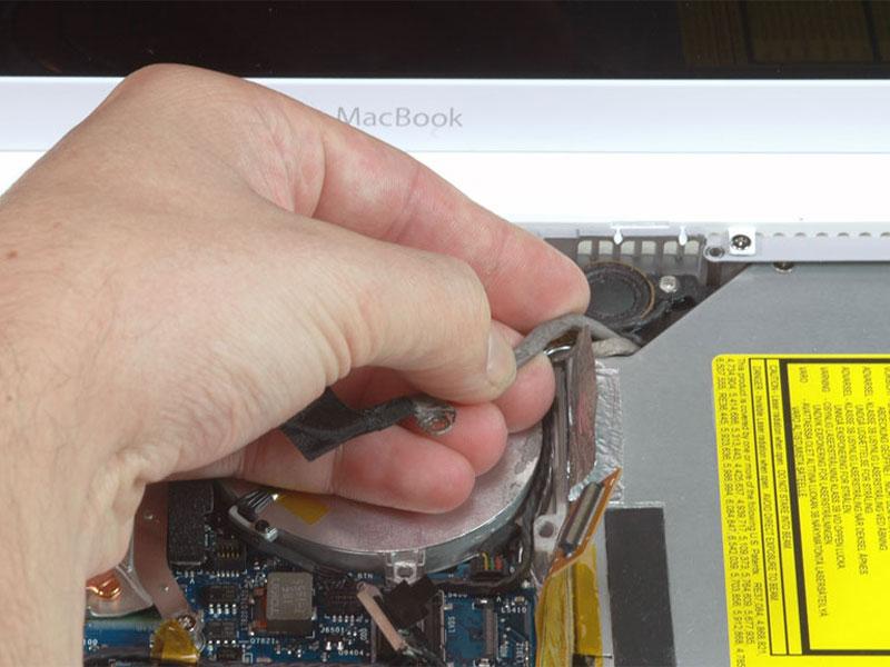 Step 19 Pull up the display data cable from along the edge of the optical drive to reveal a silver Phillips screw.