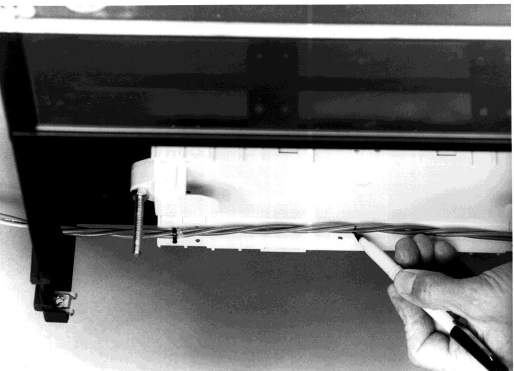 Slit the grommet in the cable entry at the rear of the cabinet on the side being used for cable entry and position the cable into the entry. Lay the fibers or the unitube into the Transition Assembly.