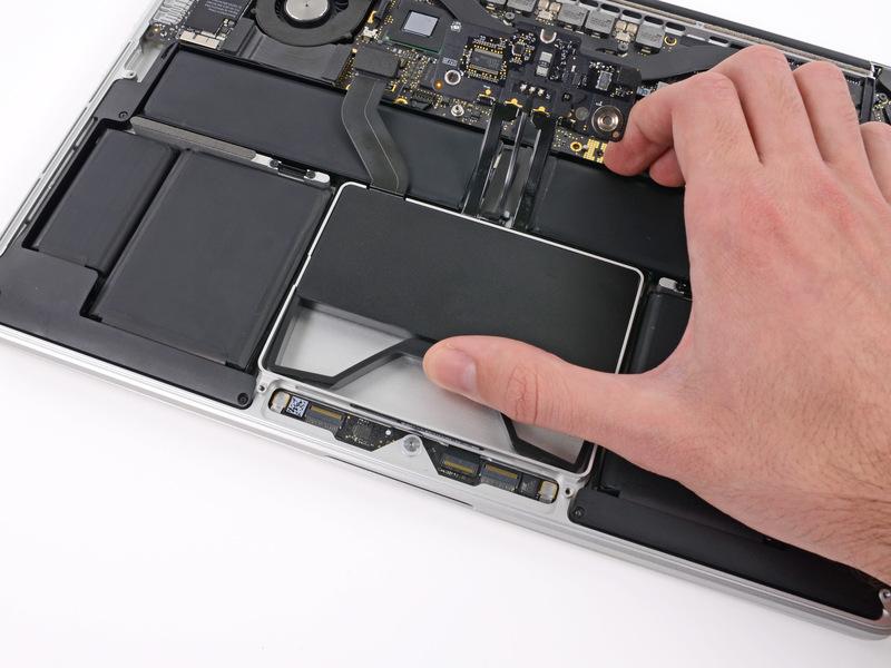 Step 11 Use your thumb or finger to bend the plastic spring bar on the SSD tray, freeing the two