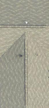 (a) (b) (c) (d) Figure 2: Pictometry rooftop sample images. (a) Intact roof. (b) Structured roof. (c) Roof with tree and dust. (d) Roof with cosmetic damage and missing shingle.