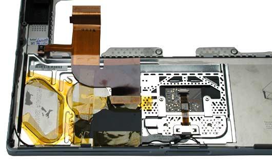 Procedure 1. With the top case on a soft cloth, notice the placement of the transparent, orange Kapton tape and the routing of the PMU ribbon cable.