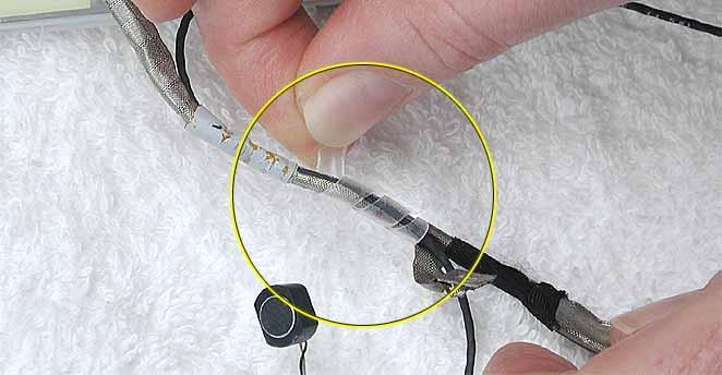 5. Warning: When removing the tape and spiral tube that bundles the microphone cable to the LCD cable, be careful not to strain or pinch the cables.