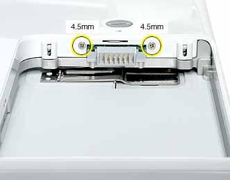 6. Remove the two identical Phillips screws next to the