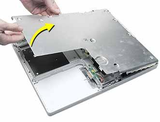 3. Warning: Do not bend the bottom shield. Lift the bottom shield off the computer, being careful where it might catch on the tape. 4.