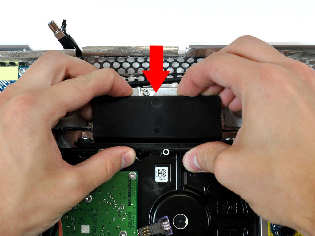 Step 16 Press the hard drive bracket down to free it from the rear case, then rotate the top of the drive toward yourself.