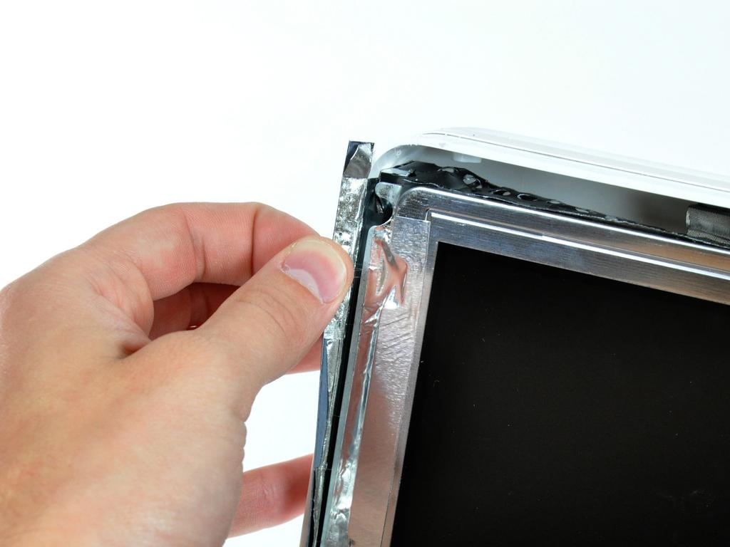 Step 11 Peel back the aluminum EMI tape from the two vertical edges of the display.