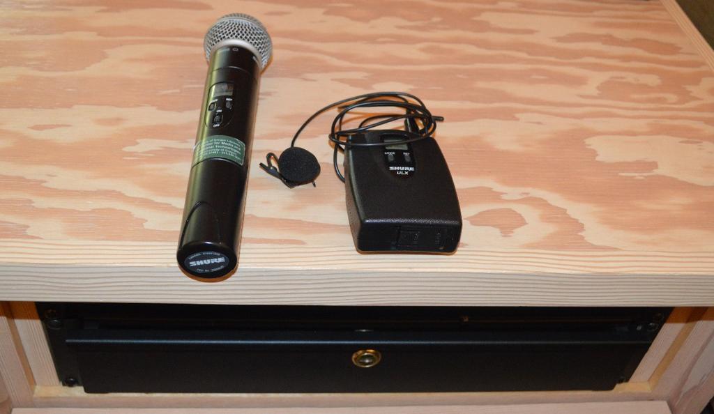 4 5. Microphone a. There are two wireless microphones located in the drawer of the AV lectern and one built-in to the presenter lectern.