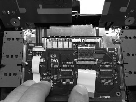 Route the factory LCD ribbon cable through the slot of the