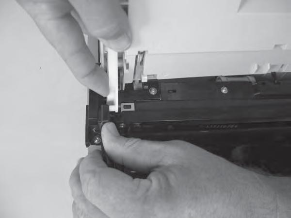 Support the door assembly, and carefully release the upper pin on the left-side