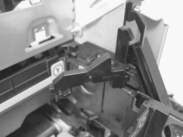 4. Rotate the cartridge-drawer retainer (callout 2) away from the chassis, and then