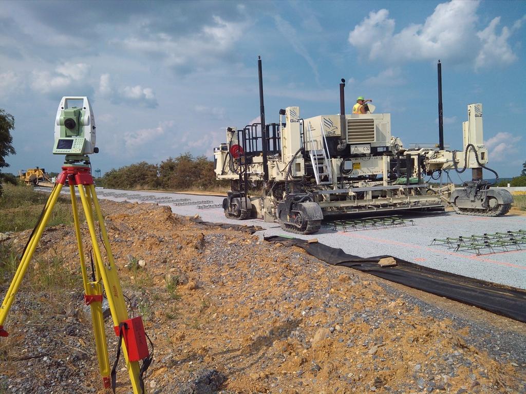 road Contractor Calibrates the Paver ON PAVE DAY: Contractor sets up (2) total stations backsights the instruments based on the surveyors control points and tracks