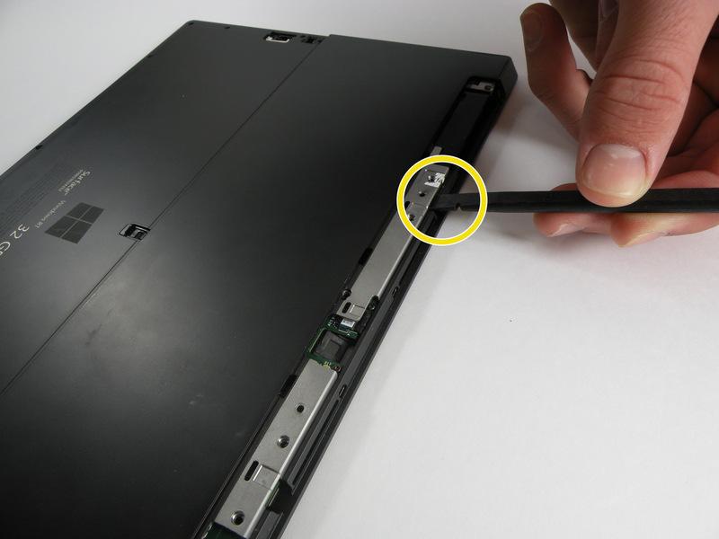 Disconnect the rear cover from the main shell of the system by loosening it with a spudger where the gaps exist.