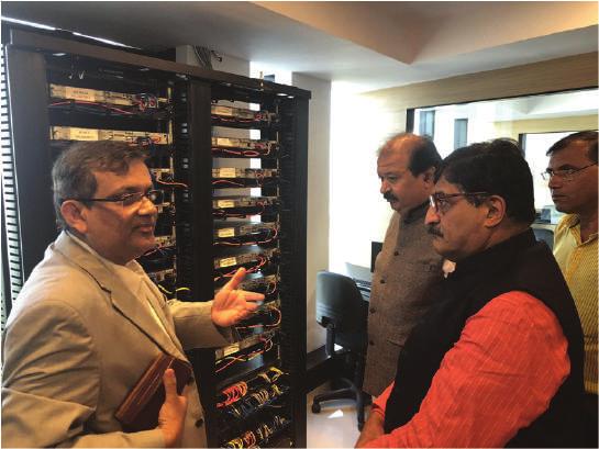 Mr. MH Noble, CEO, Zoom Technologies, giving a tour of the state of the art lab to Sri Purnesh Modi and Sri Atul Shah The Center for Excellence in Cyber security is being established in partnership