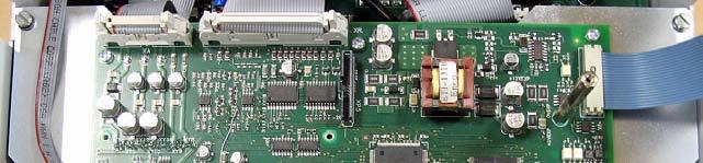 Loosen the two captive screws at the top of the Control EMI shield and lower the shield.