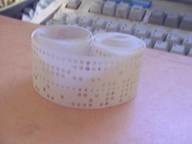 older dots / bits were positioned on the left side. Fig. 2. Typical punched paper tape storage media one row of holes consists of 3 + 4 data bits and synchronization / drive track between them.