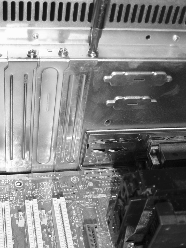 Adding an Expansion Card Figure D.15 Removing the slot cover. 4. Locate your available expansion slots.