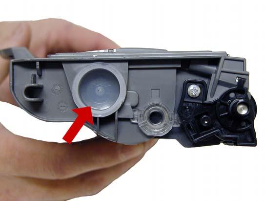 Vacuum the exterior of the cartridge. 2. Remove the fill plug from the toner cartridge.