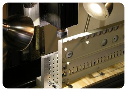 To cut holes in the back of the case, we use a "computer controlled" milling machine, which gives a precise cut.