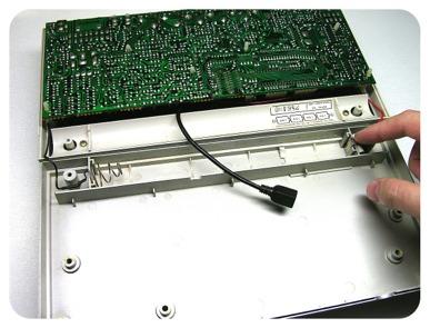 With the machine facing down, place the case bottom onto the PCB, making sure that