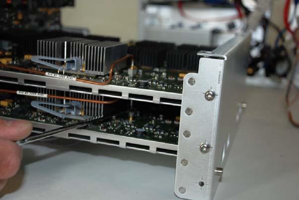 2 Remove the four M4 screws (two per acquisition assembly) on the side of the backplane assembly (Figure 5-36).