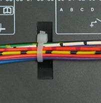 This additionally provides strain relief to the cable loom by removing the weight of the loom from the screw connectors, thus
