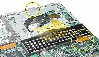 Some components could become loose and fall out. Turn over the computer and carefully pry up the DVD-ROM drive cable connector to disconnect it from the logic board.