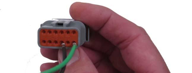 5. Insert the ground terminal into pin 4 Accessory Ground input of the Deutsch connector until it snaps into place. 6.