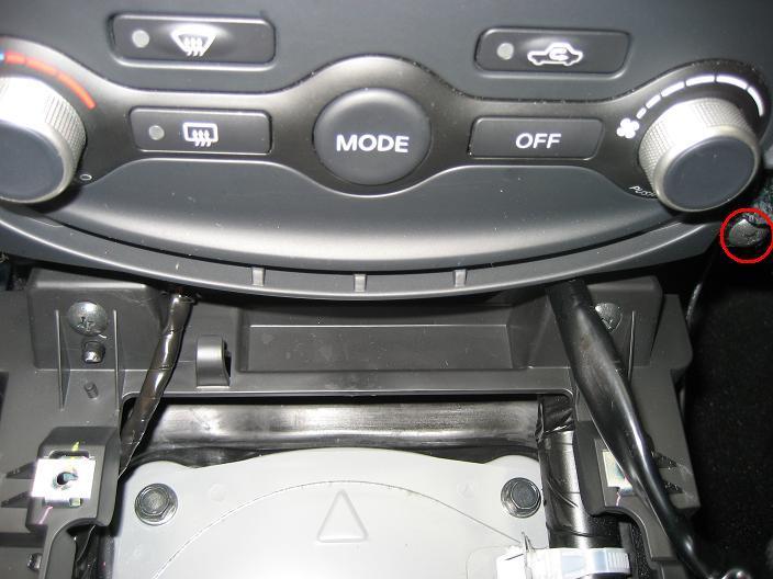 With these gone you can pull the bottom of the console toward you to unclip it from the dash board.