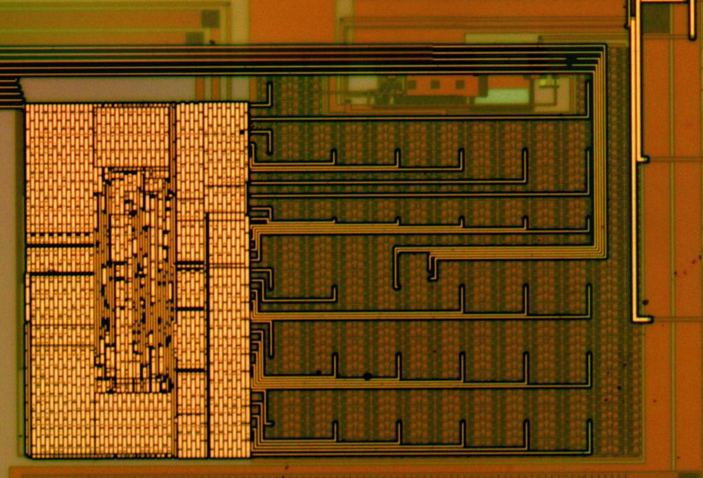 Figure 7: Normal microscope image of a current mode DAC, implemented on first run. At left, the thermometer decoder, which is (mostly) obscured by metal fill.