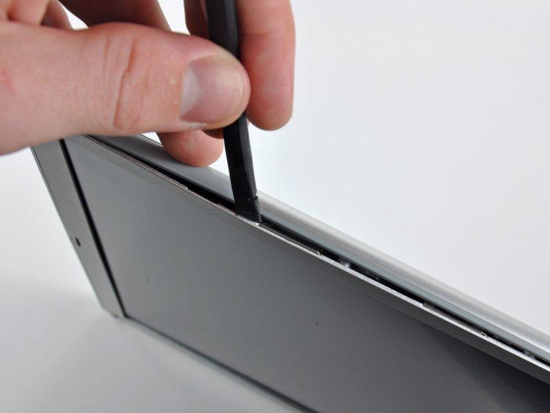 Rotate the tool away from the LCD to pop the rear bezel off the tabs on the front display bezel.