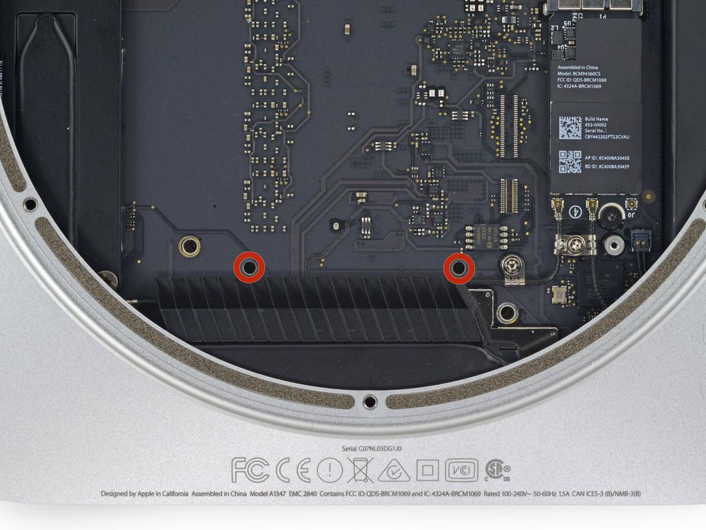 Step 22 To remove the logic board, the two cylindrical rods of the Mac mini Logic Board Removal Tool must