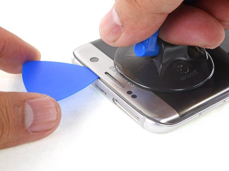 Lift on the suction cup to create a small gap underneath the top edge of the display.