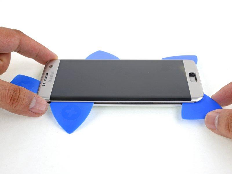 Step 30 Use the opening picks to slice through adhesive around the home button and any