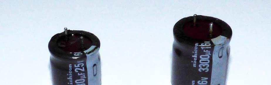 Figure 4: The two main culprits leaking electrolytic capacitors. Note the low height. I replaced the two electrolytic capacitors but was not able to find replacements with the same height.